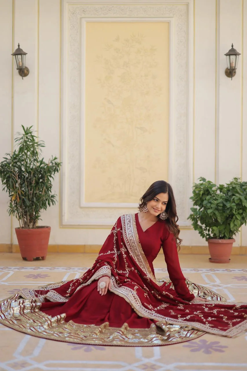 maroon long gown seated with zari jaal dupatta spread