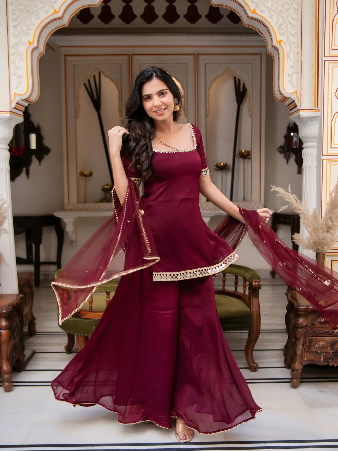Maroon mirror work palazzo set for women — flowing dupatta dancing pose