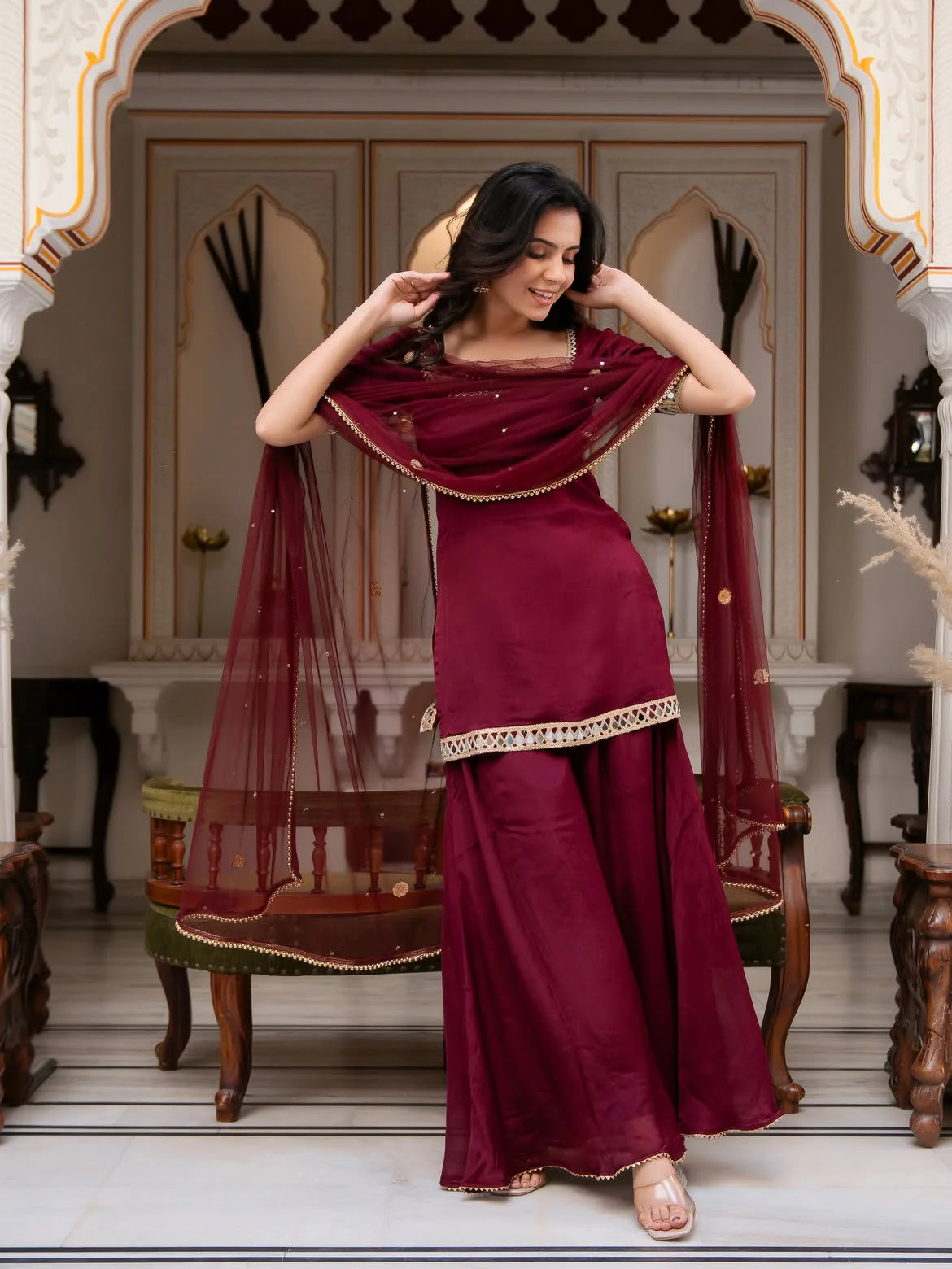 Maroon palazzo set with net dupatta — model holding dupatta showing palazzo pants