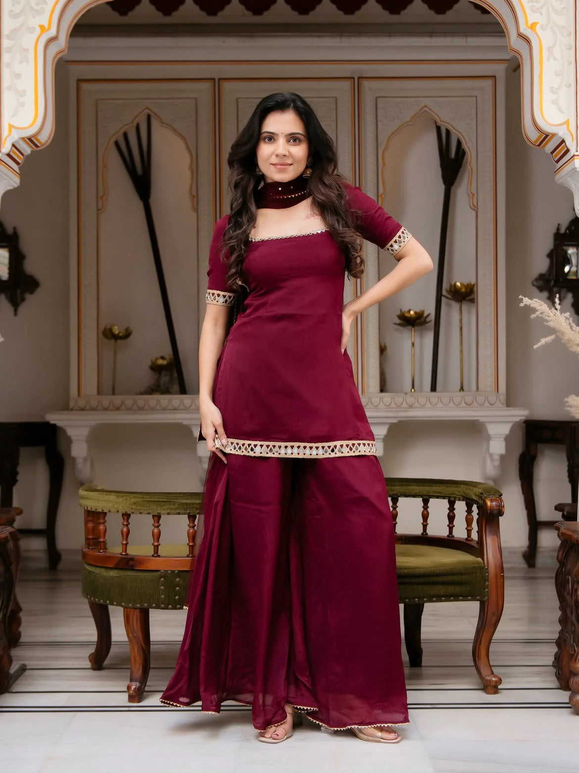 Maroon palazzo set for women with real mirror work — full front view heritage palace setting