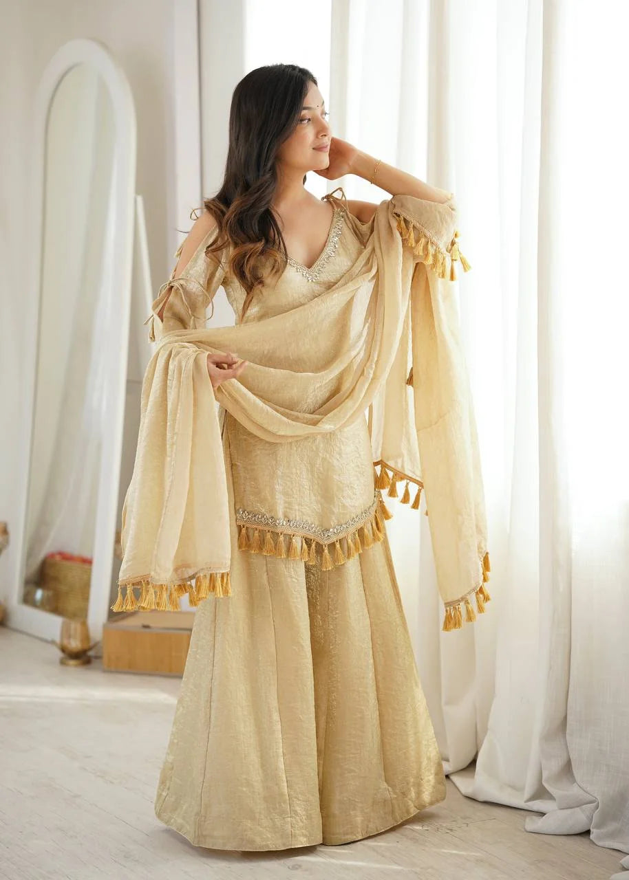 Full front view of champagne gold mirror work palazzo set for women with tassel fringe