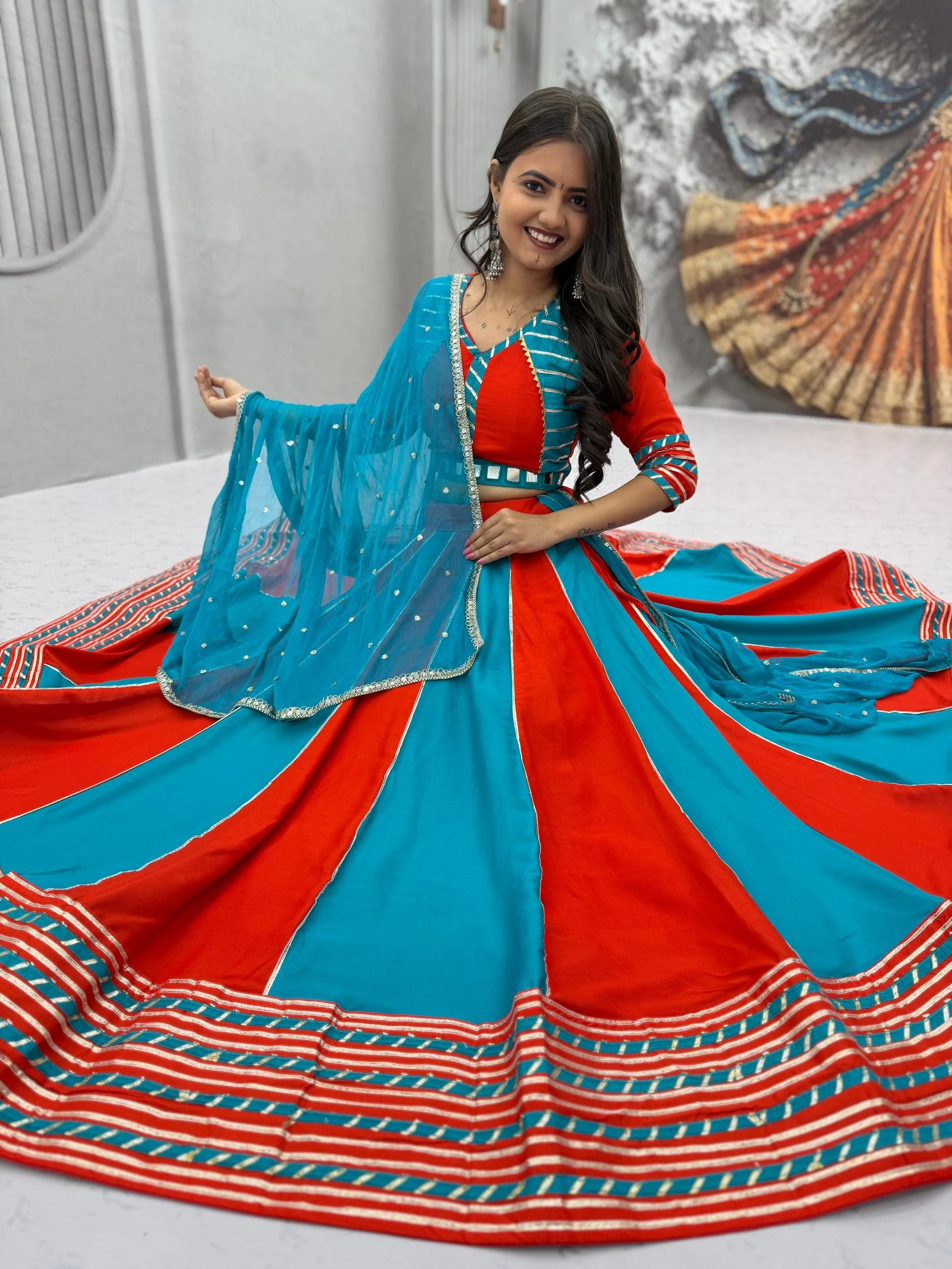 Cotton navratri lehenga choli red teal bicolor seated view with dupatta