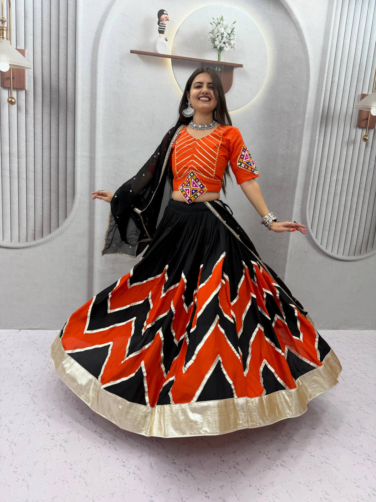 Navratri lehenga choli maroon orange action pose Navratri 2026