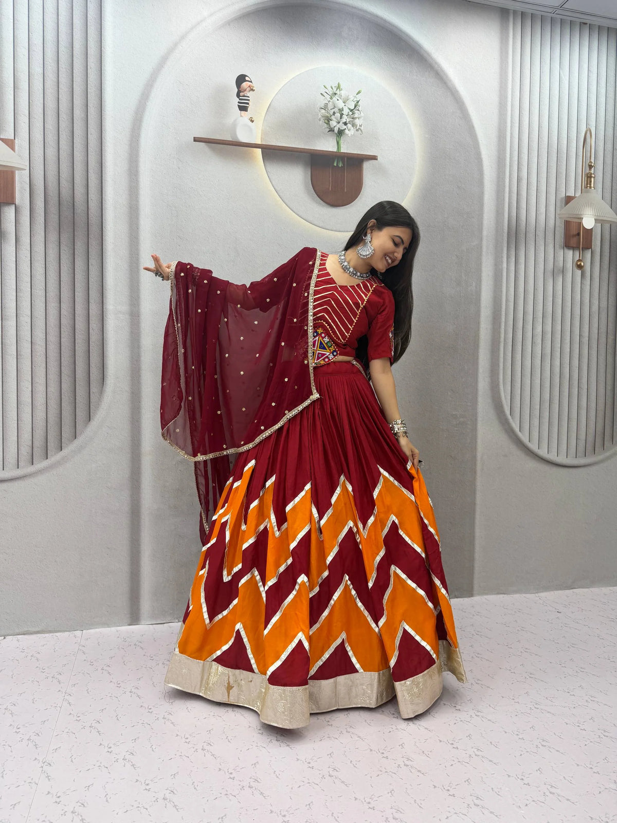 Navratri lehenga choli maroon orange dupatta flying festive pose
