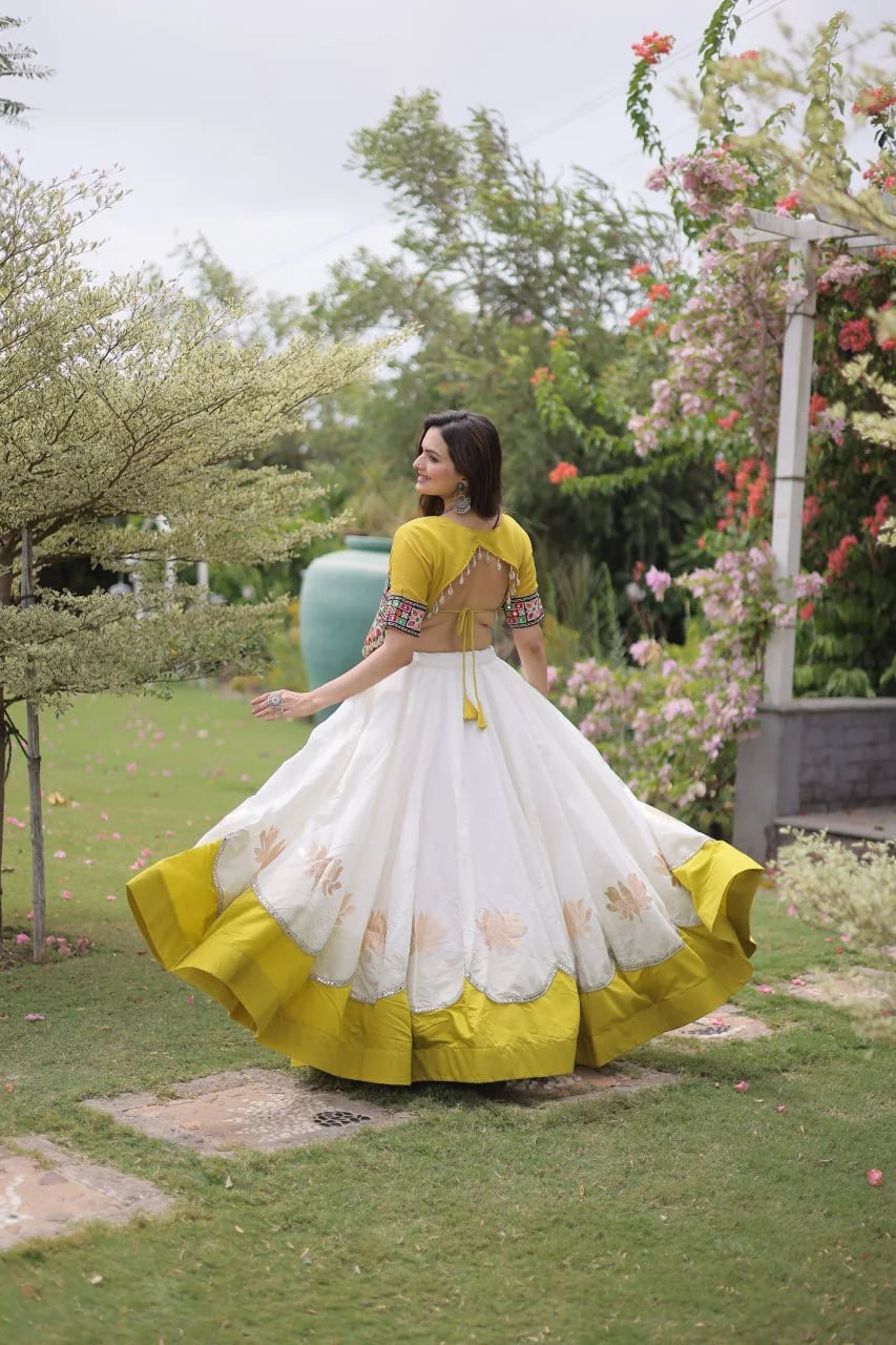 Navratri lehenga choli yellow Roman fabric top white lehenga standing front