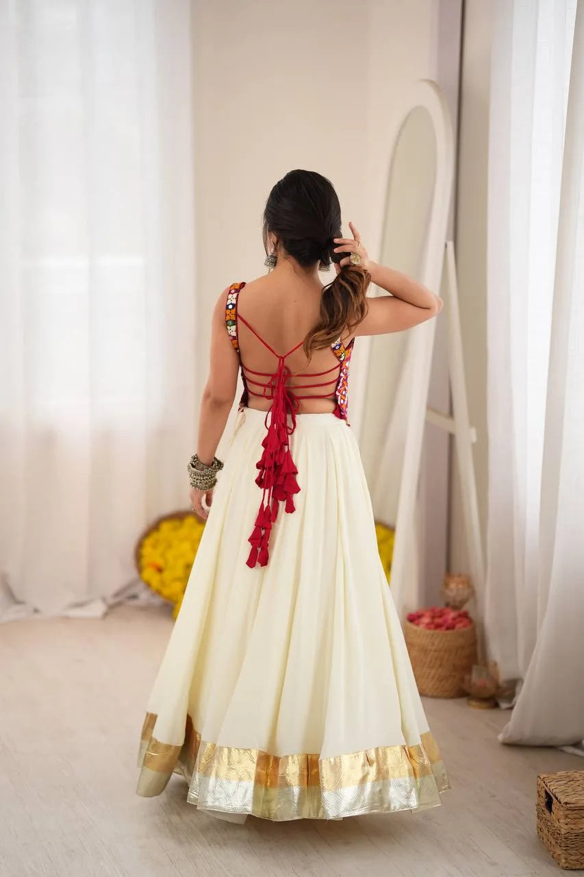Red strappy tie-back of off white navratri chaniya choli with multicolour mirror-work choli — back view