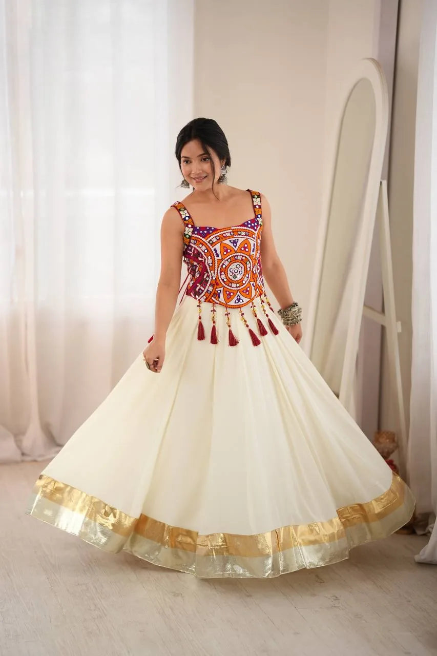 Off white navratri chaniya choli with cream rayon flair and gold zari hem border — garba pose