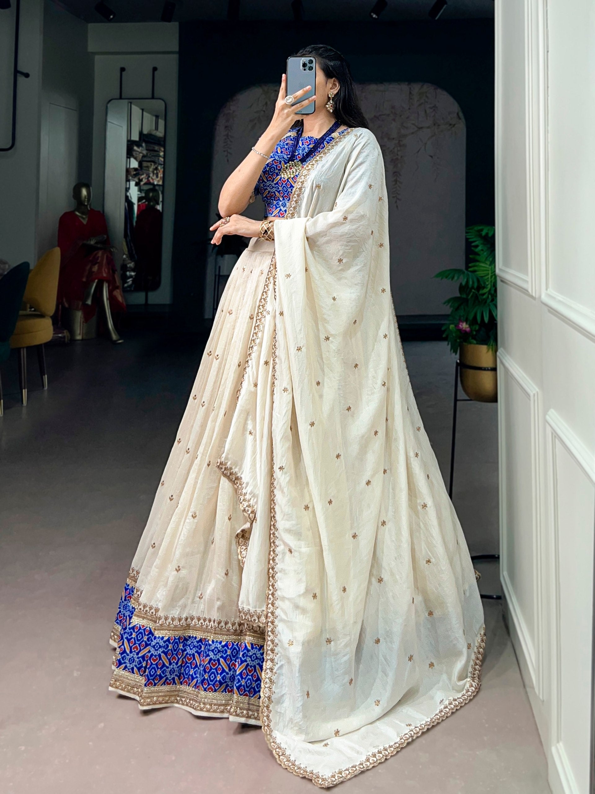 off white vichitra silk lehenga choli set with royal blue patola border side view