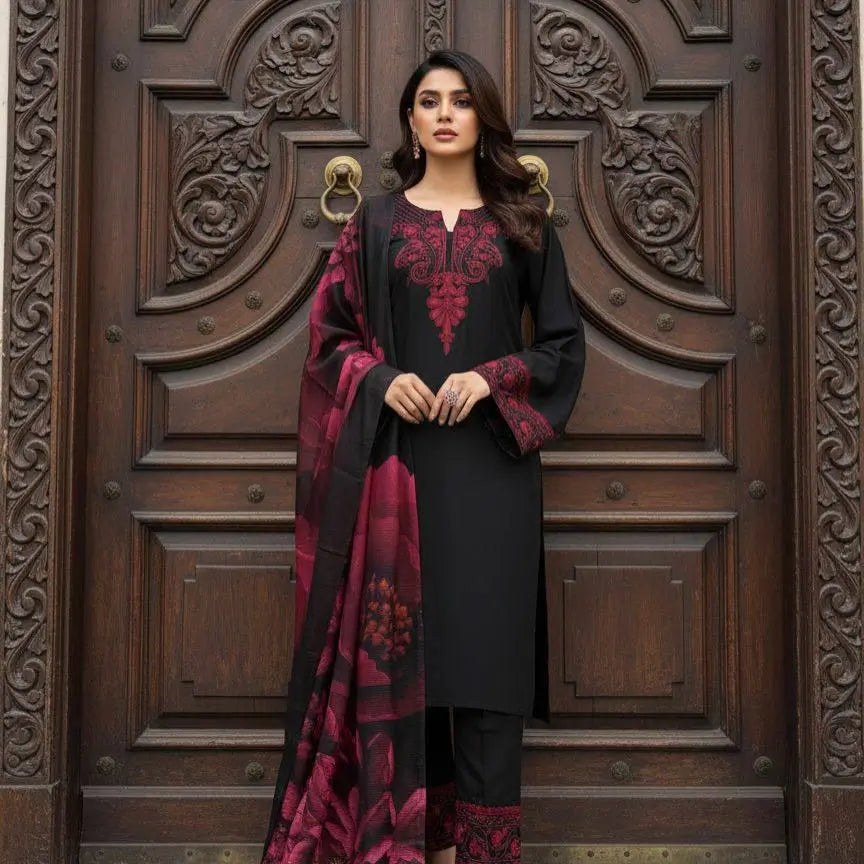 Woman in black and red traditional outfit standing in front of a wooden door with intricate carvings.