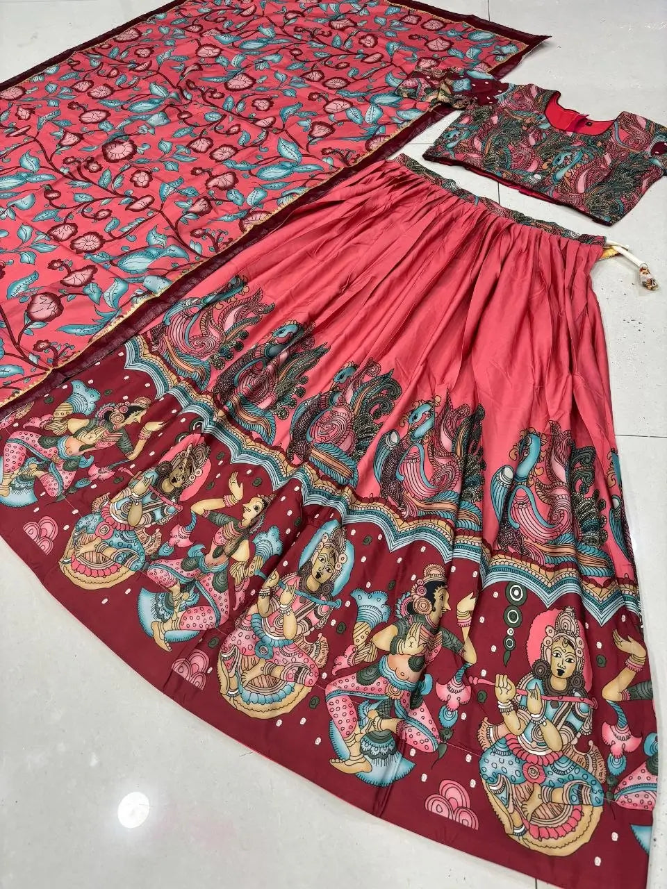 Traditional Indian attire with colorful patterns on a white background