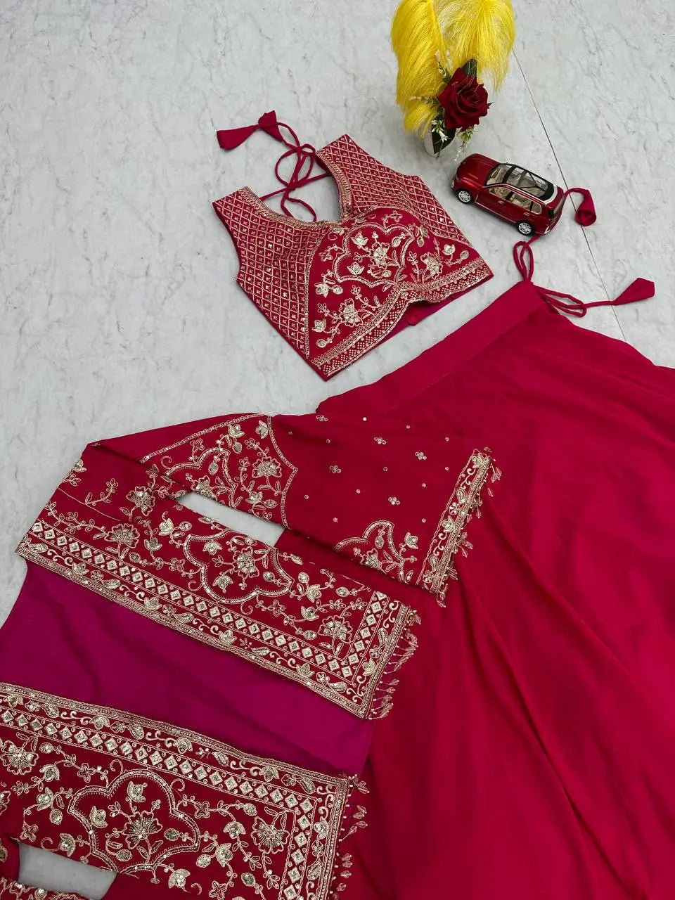 Red embroidered traditional outfit with blouse on a light gray background