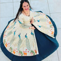 Woman wearing a traditional outfit with a floral design on a tiled floor