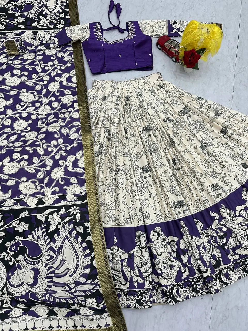 Traditional Indian saree with a purple blouse on a light gray background