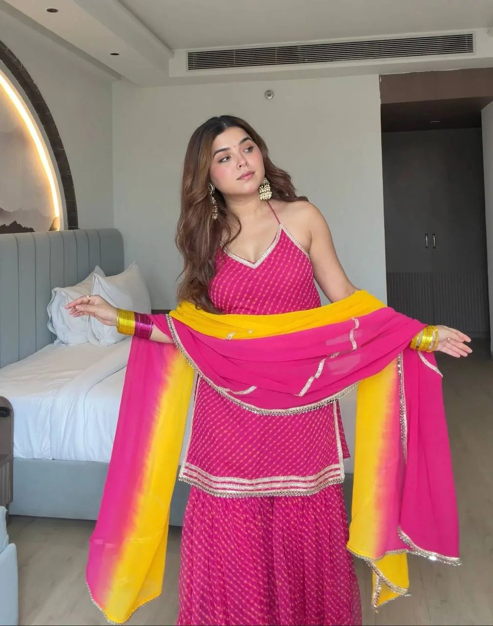 Pink georgette sharara set dupatta spread showing yellow ombre gradient and lace detail