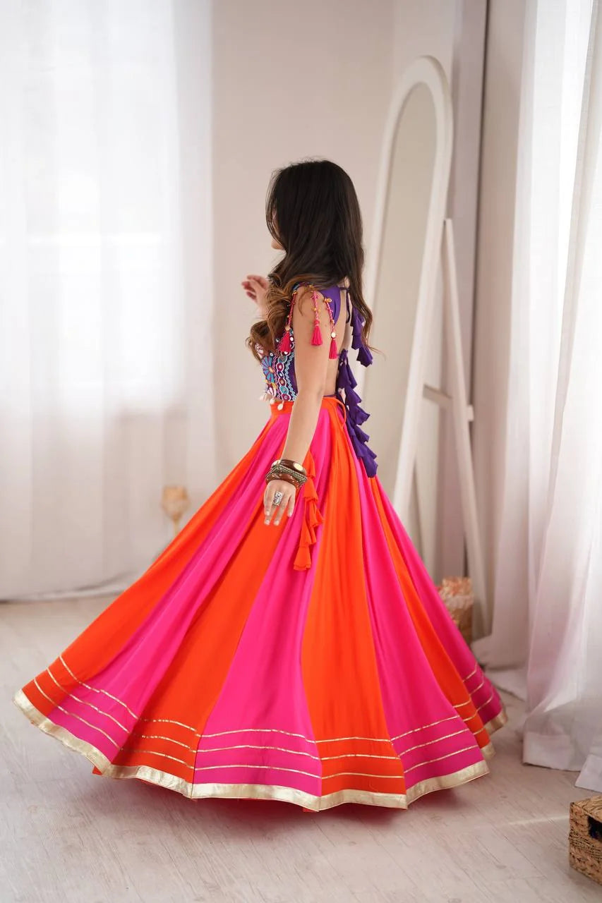 back view of pink orange navratri lehenga choli with open back tassels