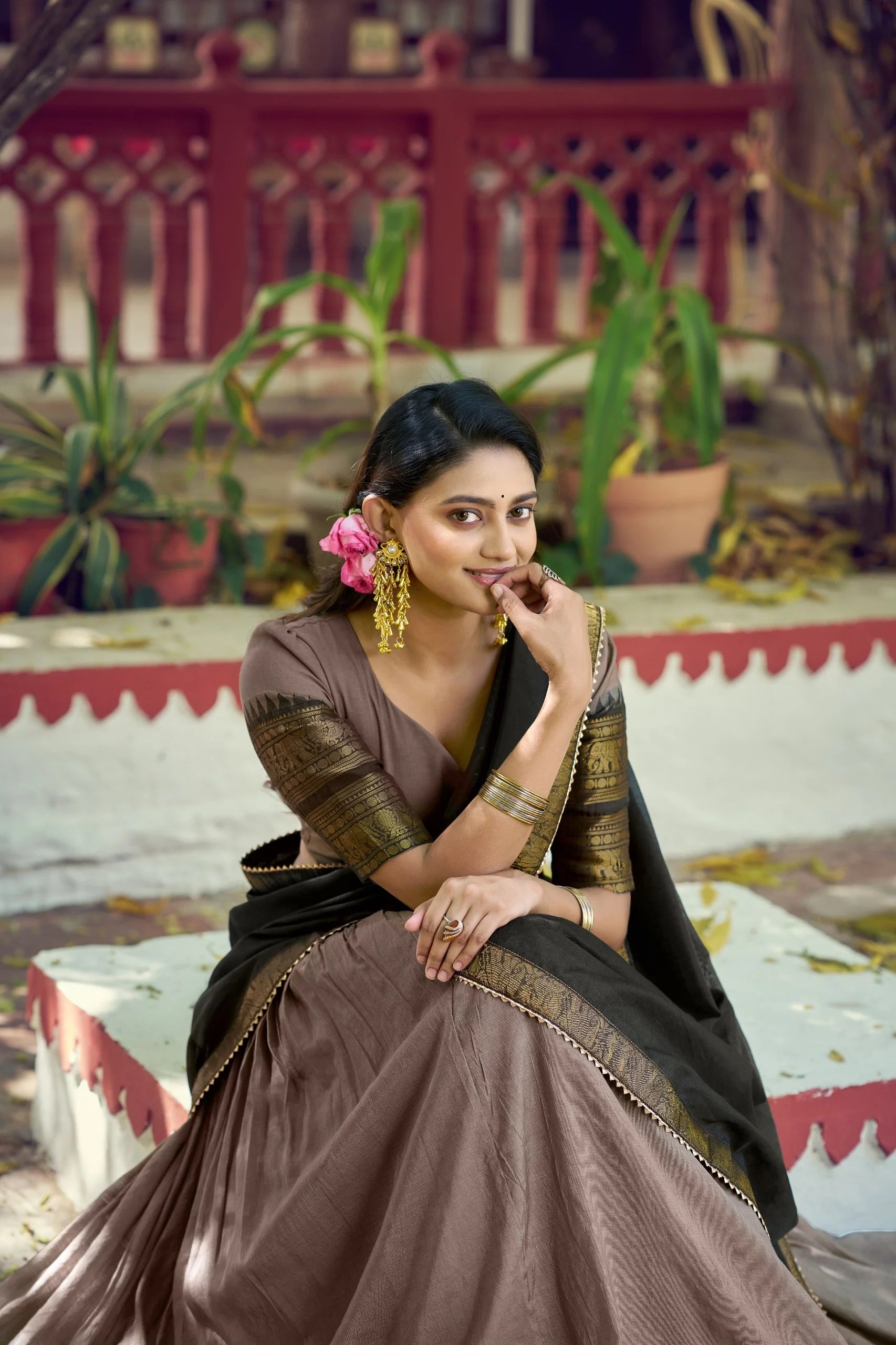 brown poly cotton lehenga choli zari border sitting outdoor black dupatta