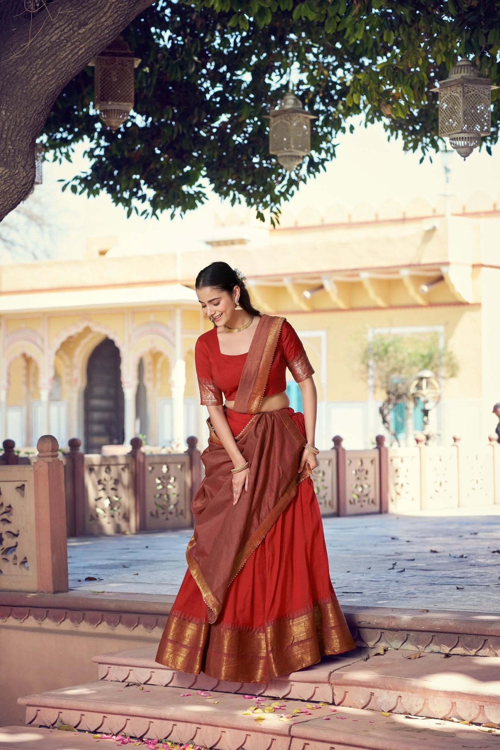 red poly cotton lehenga choli gold zari border palace steps full length