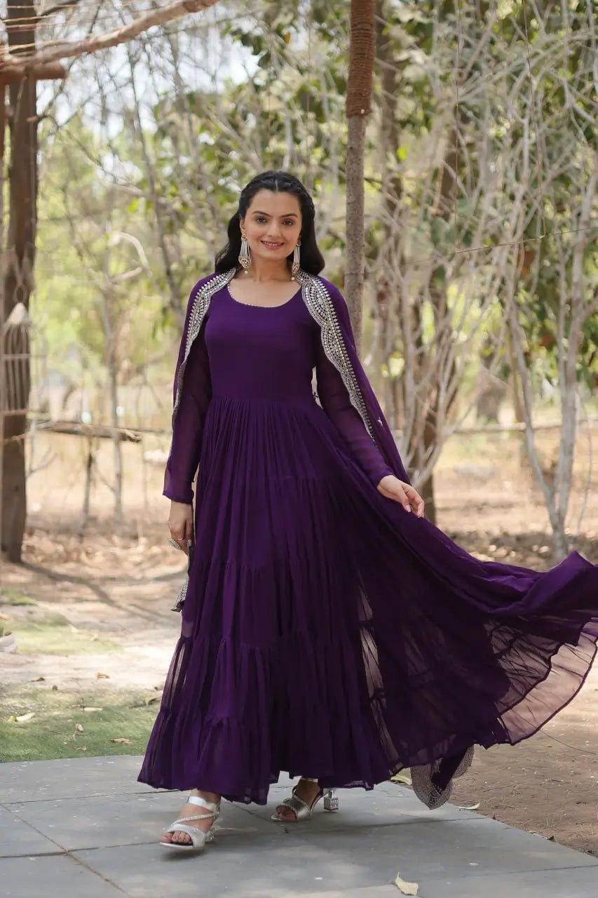Royal purple faux georgette tiered anarkali gown showing flare in walking pose – side view