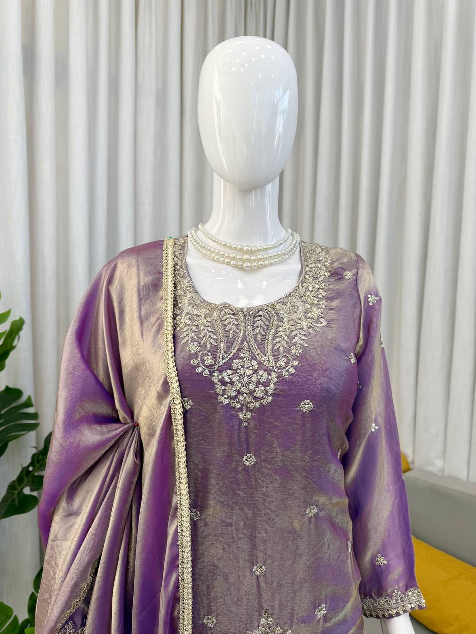 Close up of lavender kurta fabric with detailed embroidery and texture design