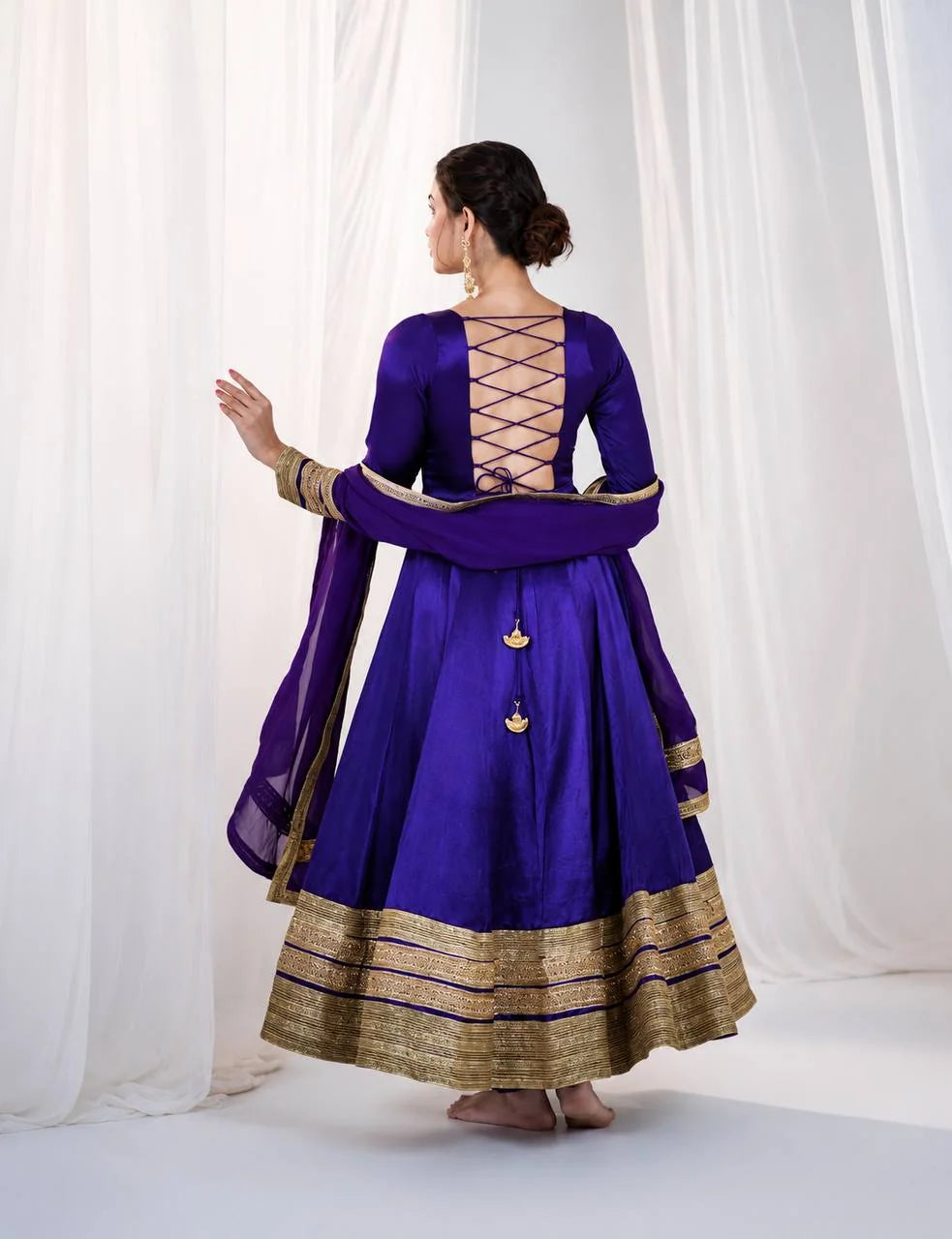Lace-up back design detail on purple silk anarkali gown with dupatta