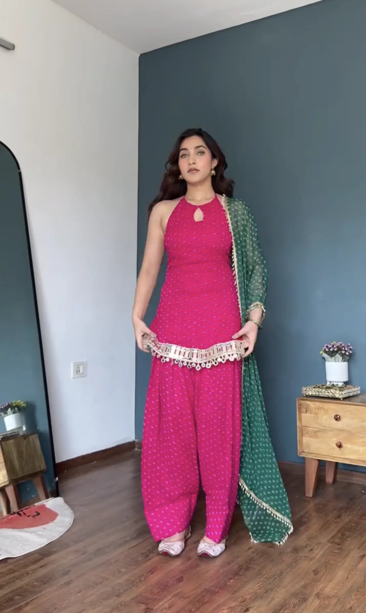Full-length rani pink bandhani foil georgette kurta patiyala set with bottle green bandhani dupatta and gold ghungroo border — front view