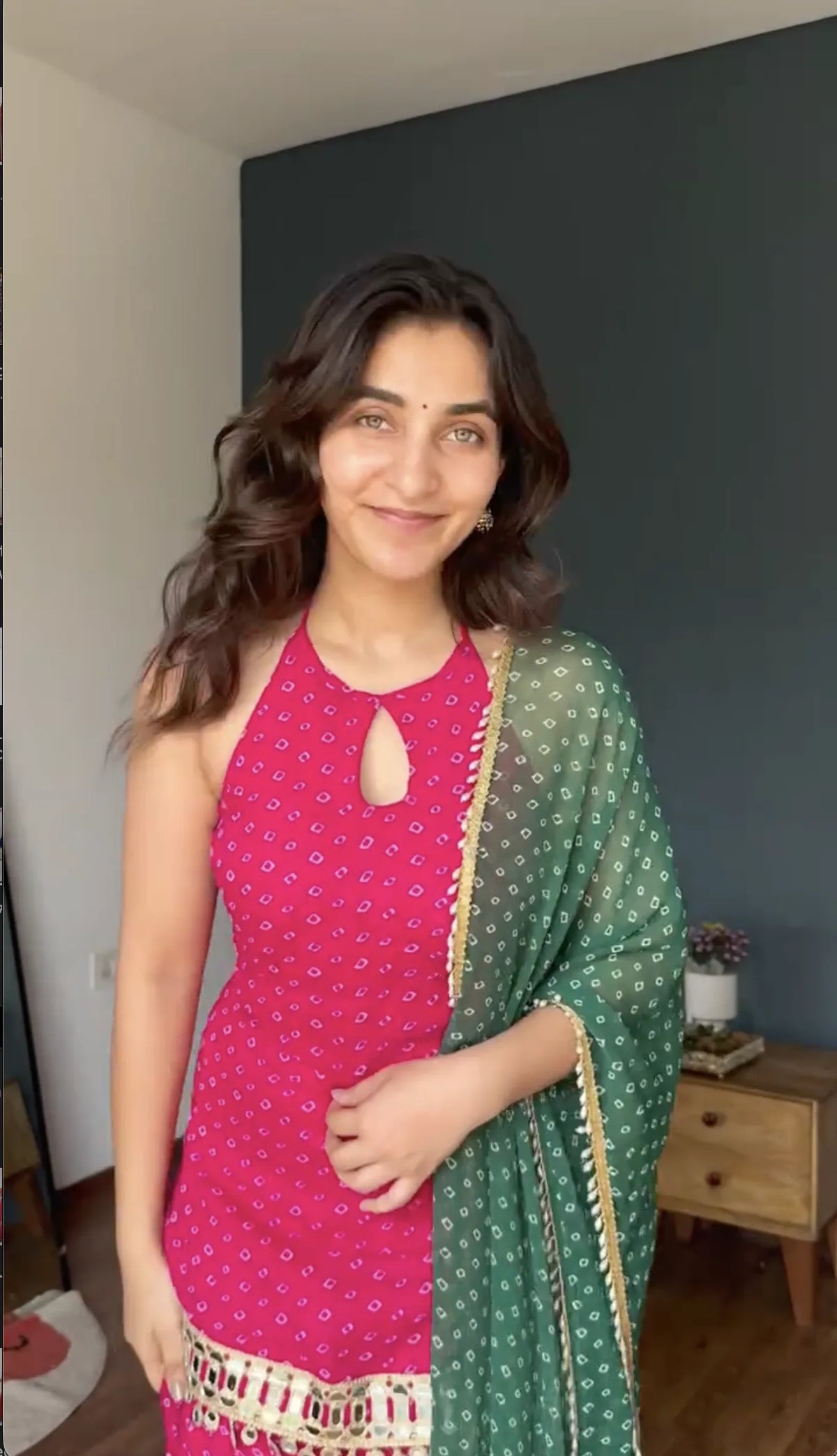 Keyhole halter neckline on rani pink bandhani foil georgette kurta with bottle green bandhani dupatta — close-up