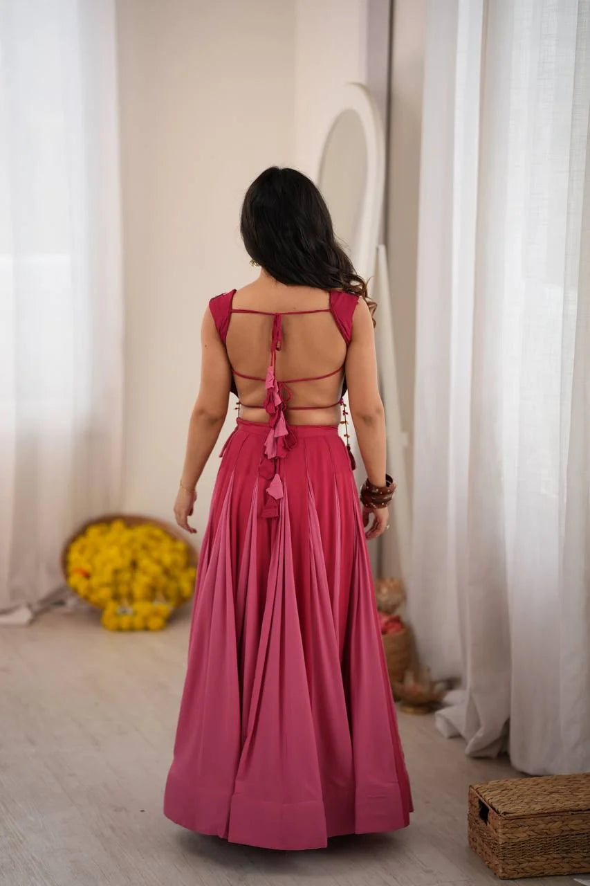 backless tie-up detail of rani pink crop top lehenga with latkan tassels