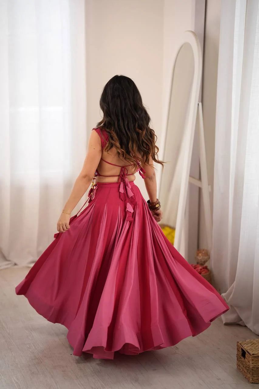 back view of rani pink crop top lehenga with tie-up choli and box pleat skirt