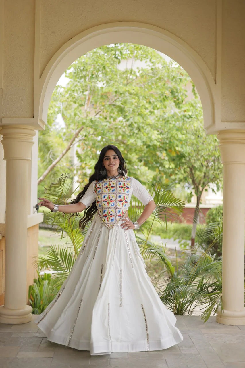 White rayon chaniya choli twirl showing the six-metre mirror-lace flair, dance view