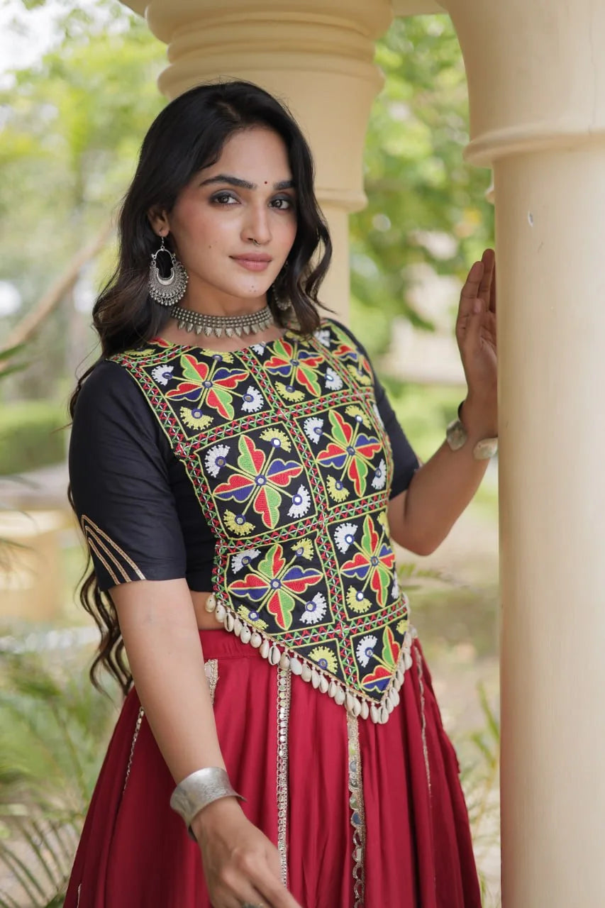 Maroon chaniya choli with black Kutchi mirror blouse and cowrie tassels, closeup