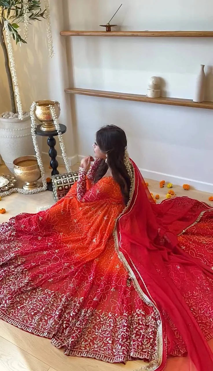 Red anarkali gown for women flat lay showing bandhani print pant and dupatta