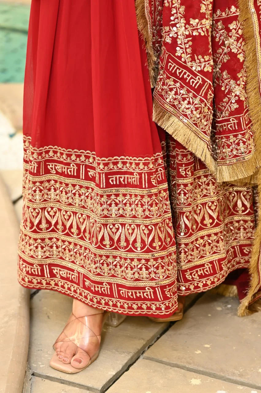 red anarkali gown gold script hem border closeup