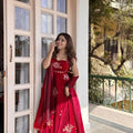 Woman wearing red embroidered Fendy silk Anarkali palazzo set with dupatta outdoor festive wear