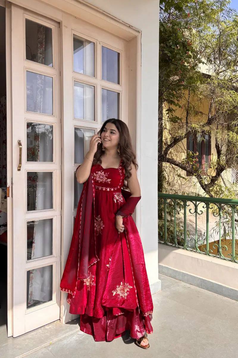 Woman wearing red embroidered Fendy silk Anarkali palazzo set with dupatta outdoor festive wear