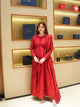 Red vichitra silk anarkali suit set with thread and sequin floral work and net dupatta — side view