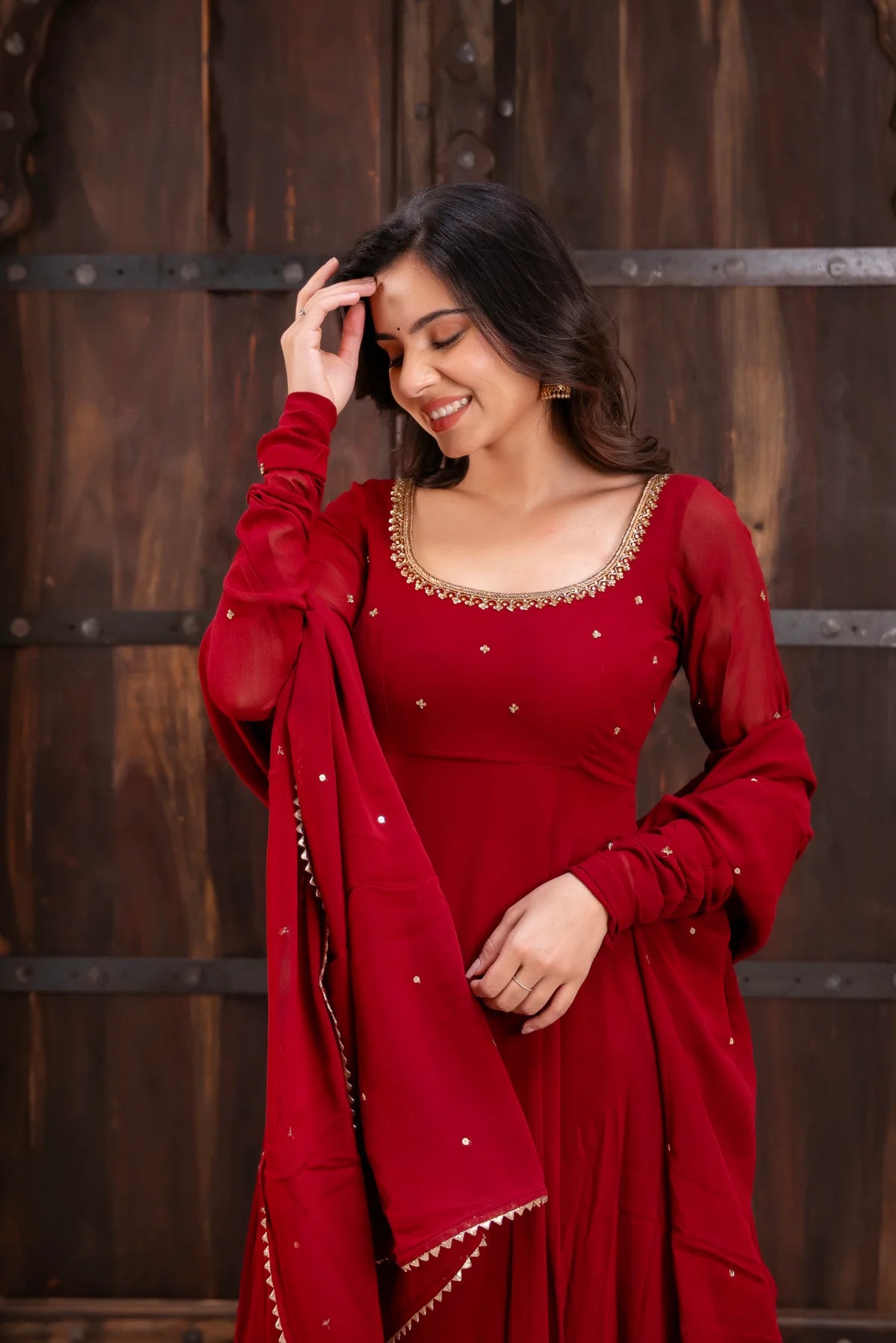 Close-up of zari sequin neckline on red georgette anarkali suit – detail shot