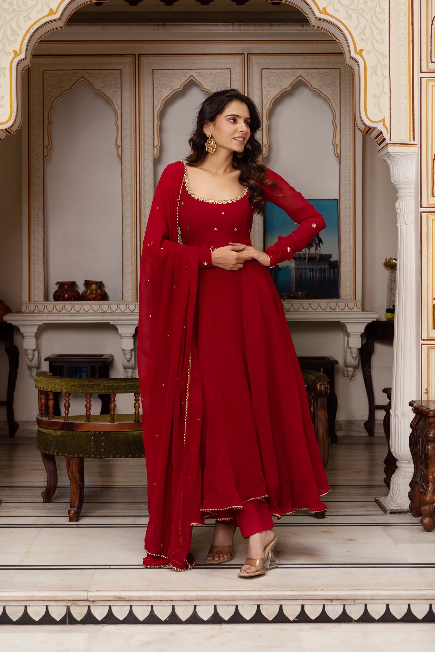 Side view of red georgette anarkali suit set showing straight pants with gold border hem