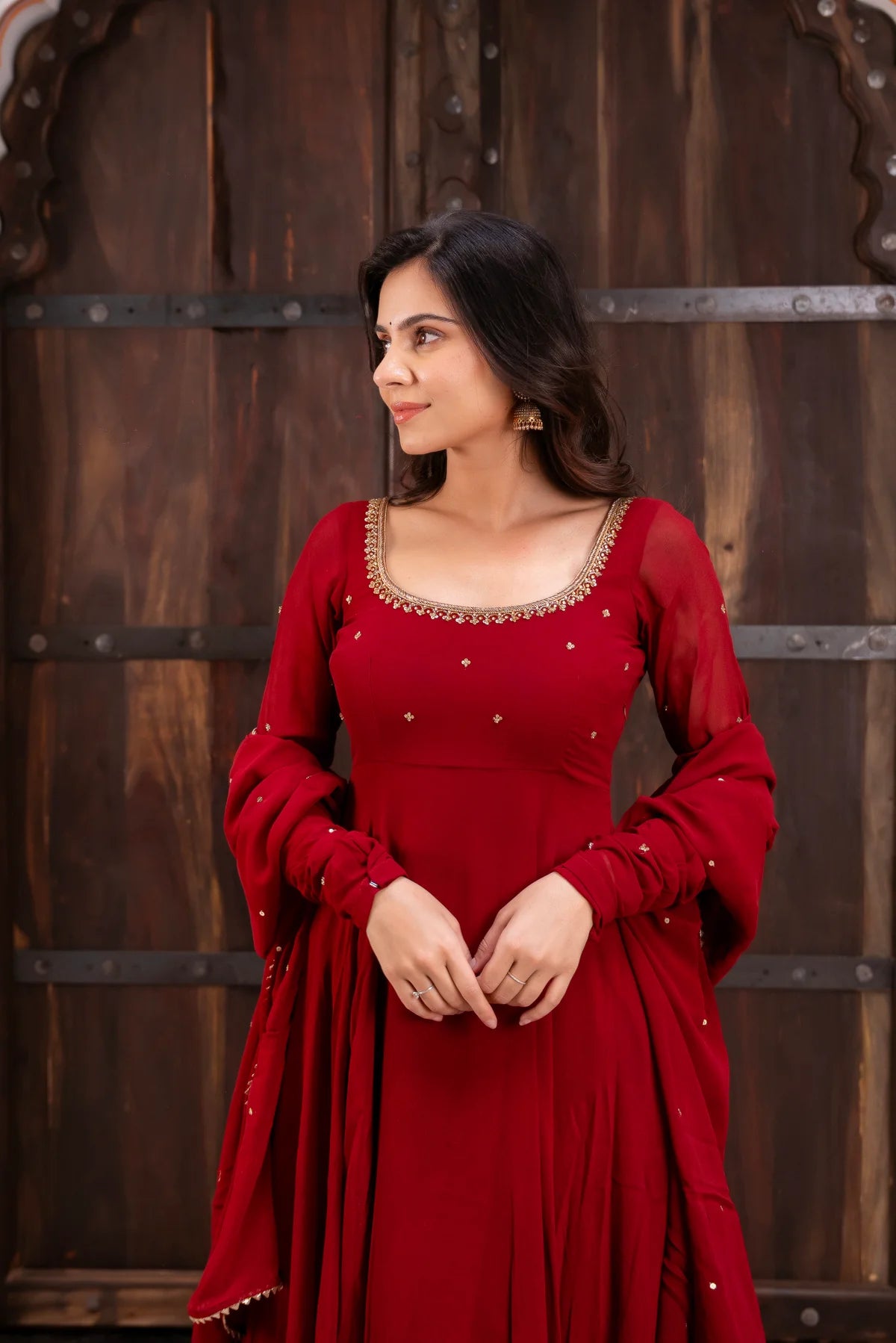 Full-length red georgette anarkali suit with zari and sequin embroidery – flare view