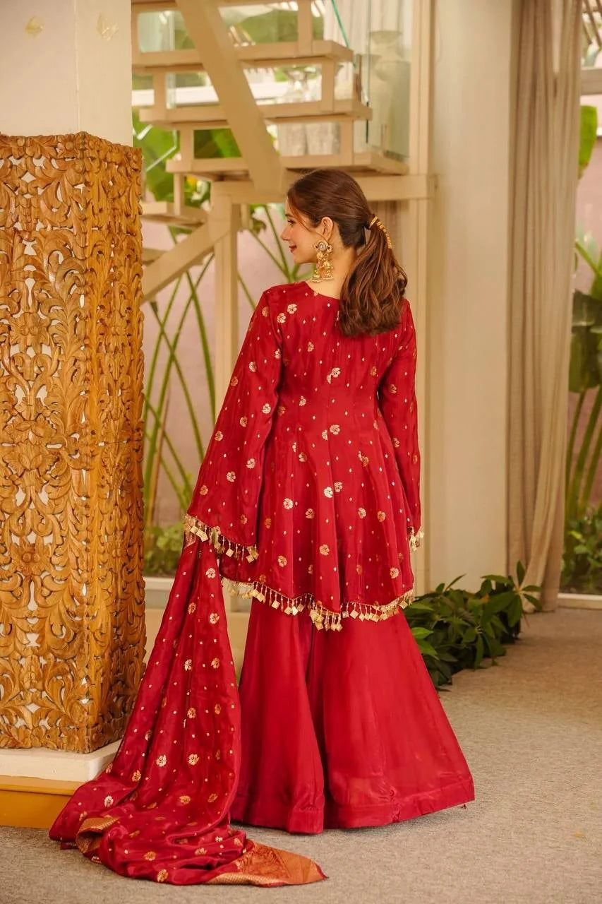 Red satin silk palazzo set back view showing woven floral butas and coin lace hem