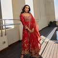 Front angle view of rust mulberry silk embroidered Anarkali set with elegant dupatta drape