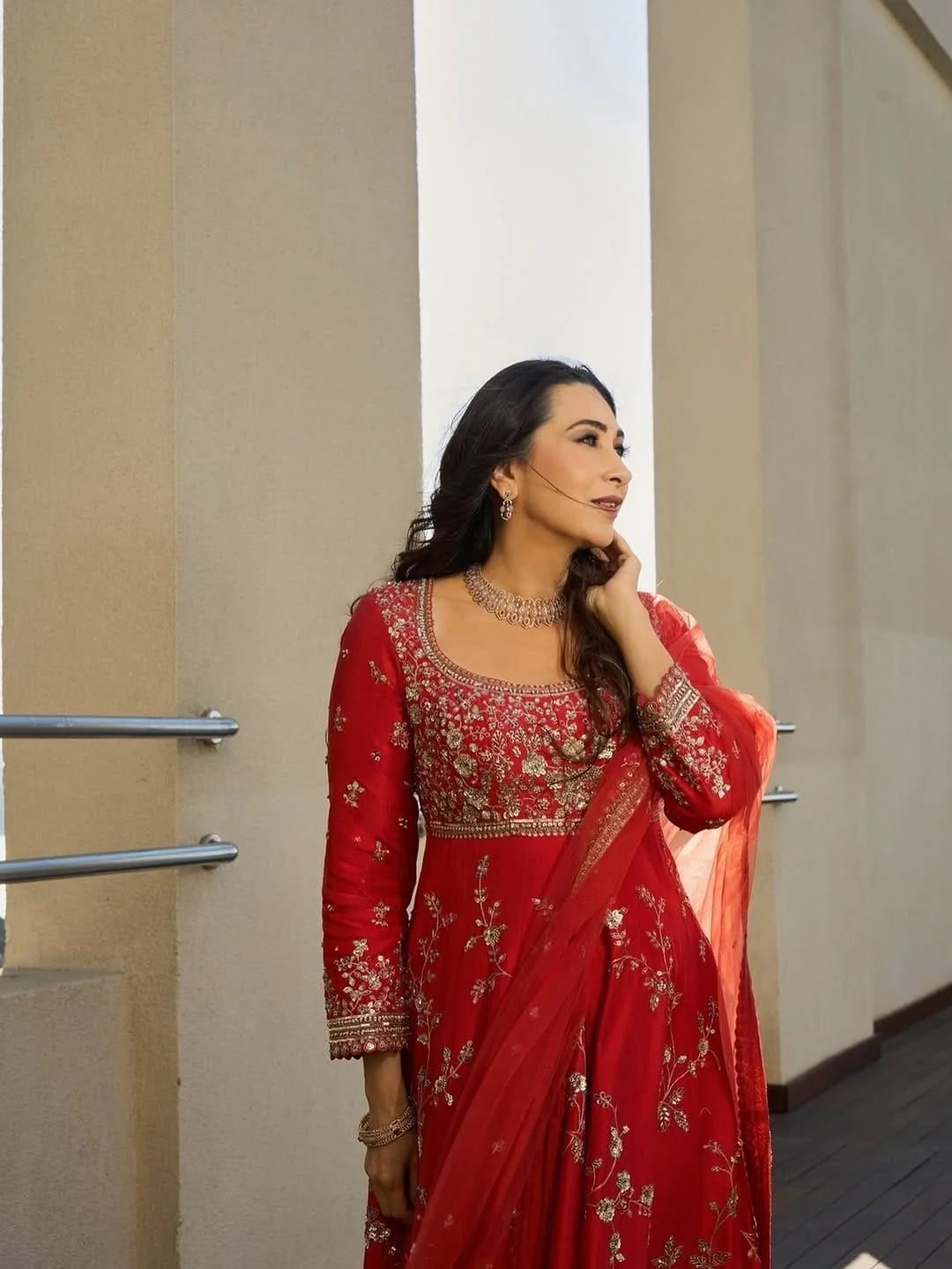 Close up neckline embroidery of rust mulberry silk Anarkali suit with zari floral work