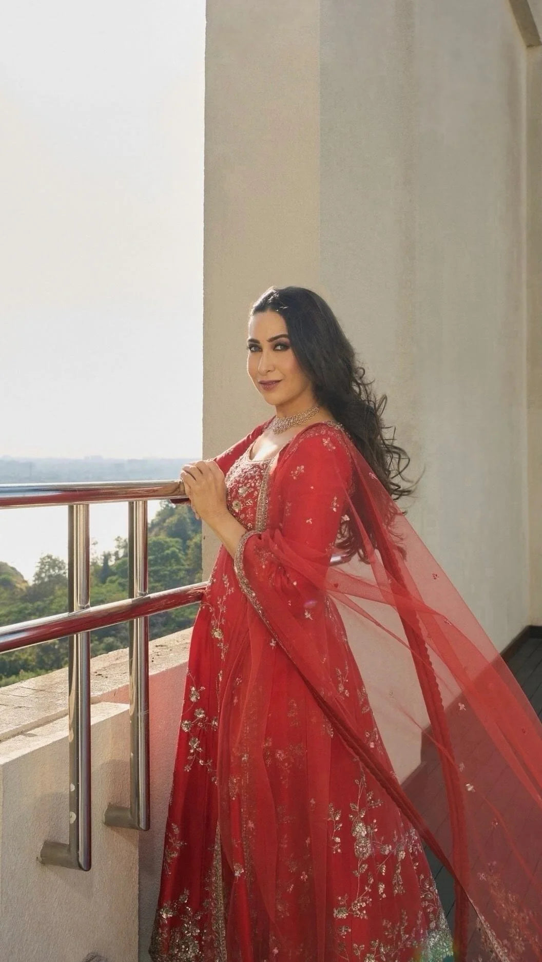 Side view of rust mulberry silk embroidered Anarkali suit with flowing dupatta