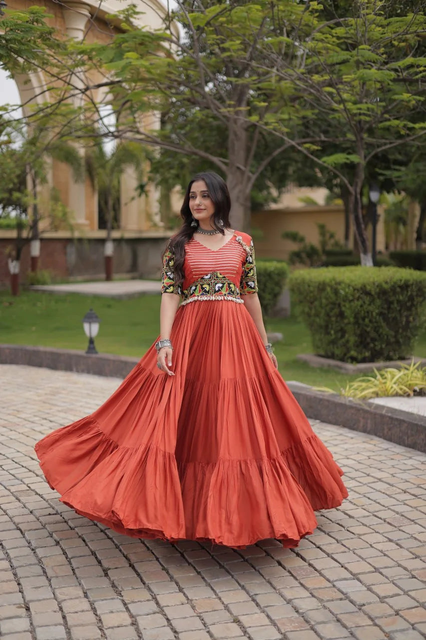 Rust navratri gown in 14kg rayon with Kutchi gamthi mirror sleeves and tiered flair, front view