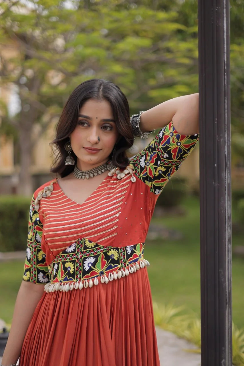 Rust gown bodice closeup with gota stripes, Kutchi gamthi belt and cowrie tassels, view