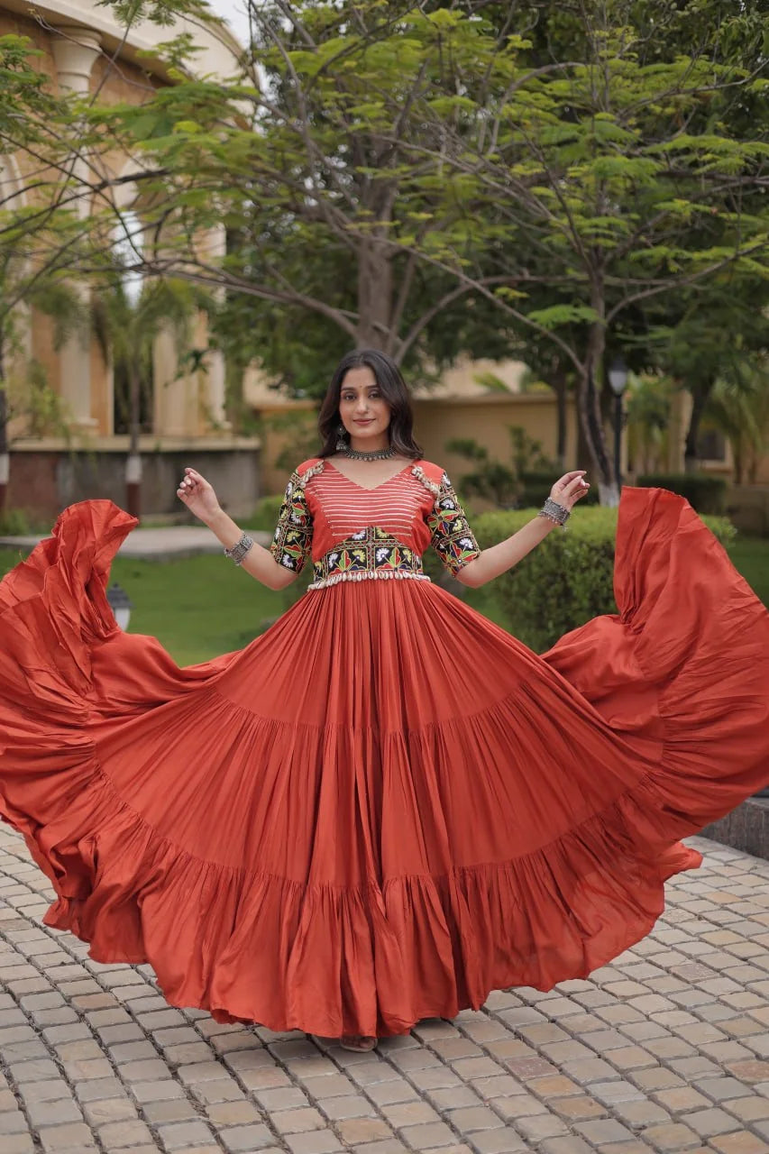 Rust navratri gown twirl showing the twelve-metre tiered rayon flair, dance view