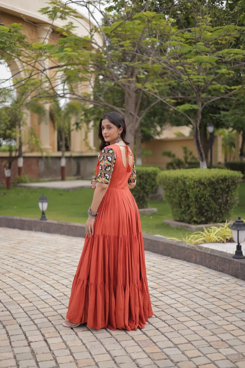 Rust gown with open back dori tie and gamthi mirror sleeves, back view