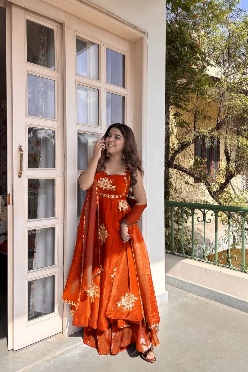 Model showcasing rust orange embroidered Anarkali palazzo set with dupatta festive ethnic wear