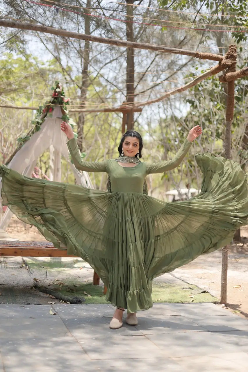 Sage green tiered anarkali gown showing full 15-metre flare – open flare action shot
