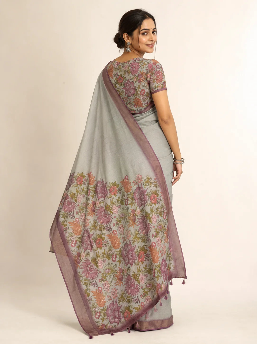 sage grey linen saree rear view with floral pallu and mauve zari patta border