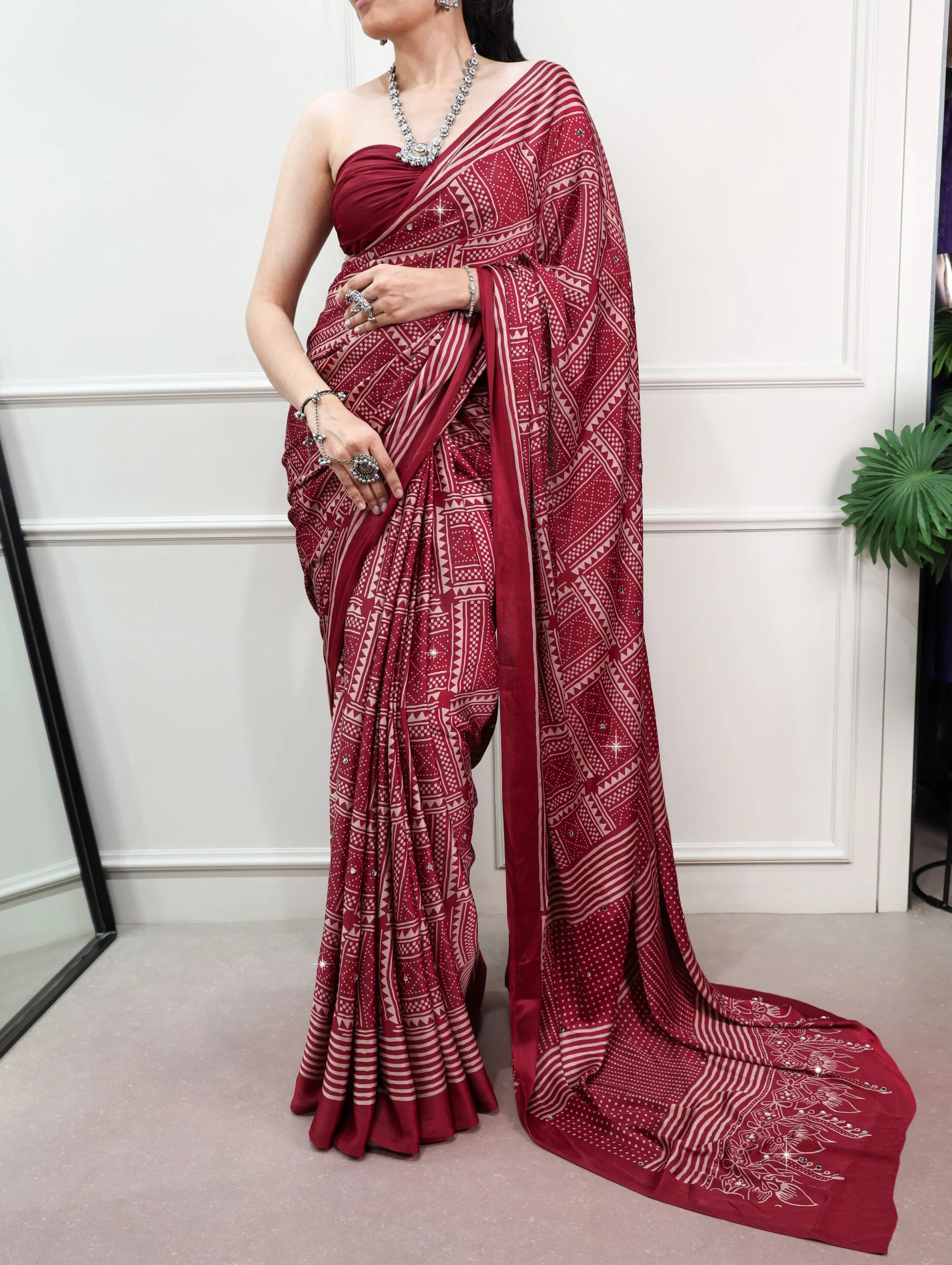 Maroon satin silk mirror work saree upper body close-up drape
